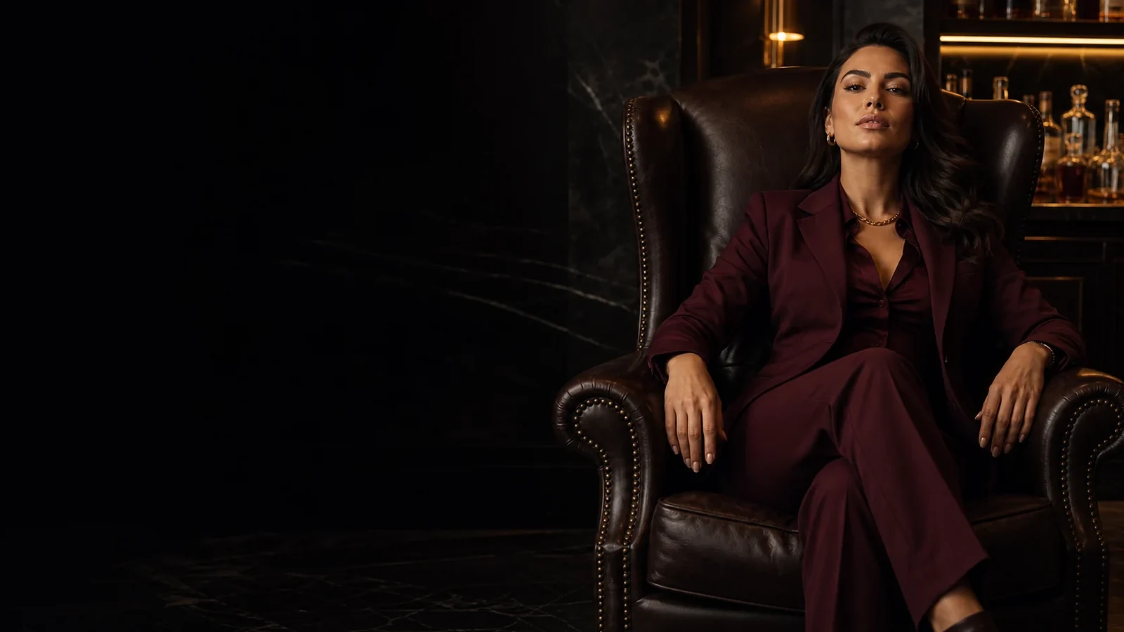 A financial dominatrix in Australia seated in a private black-marble club